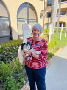 freedom village resident with her dog outside on a walk