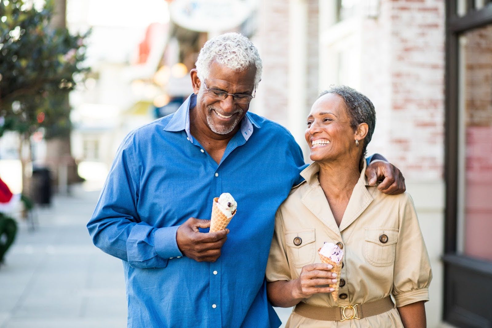 Senior couple walking down the street, enjoying ice cream