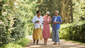 senior women laughing on a walk together outside