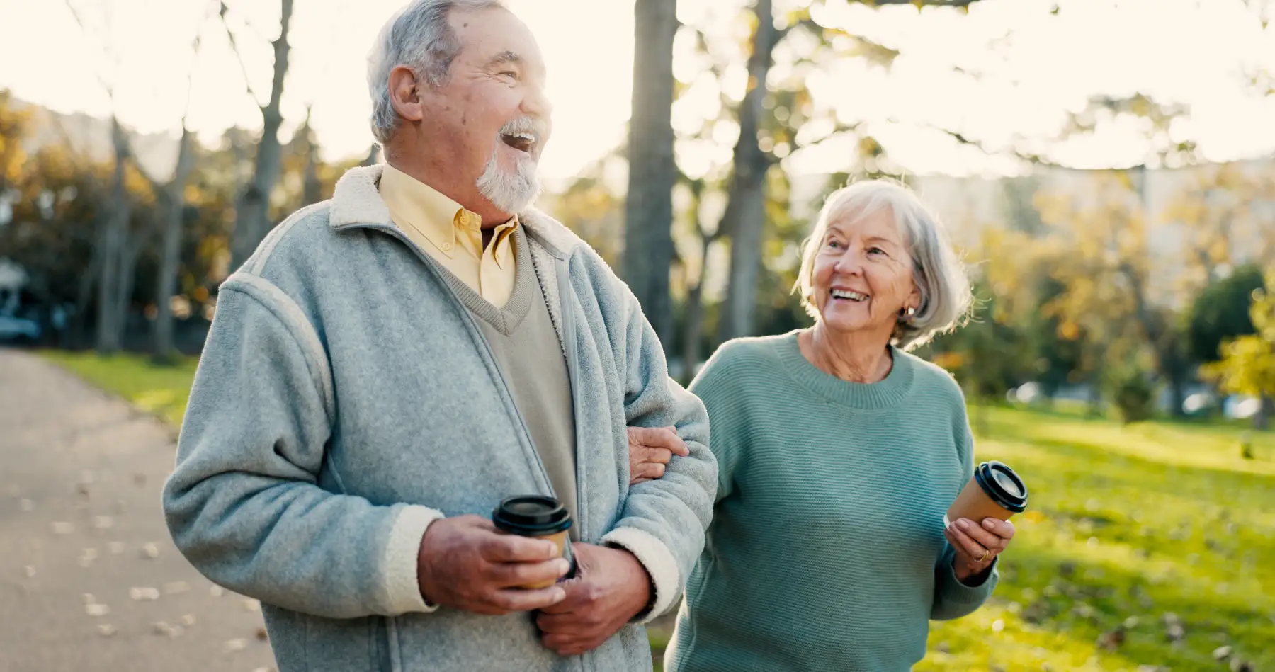 a senior couple at a Life Plan Community taking a walk on a fall day
