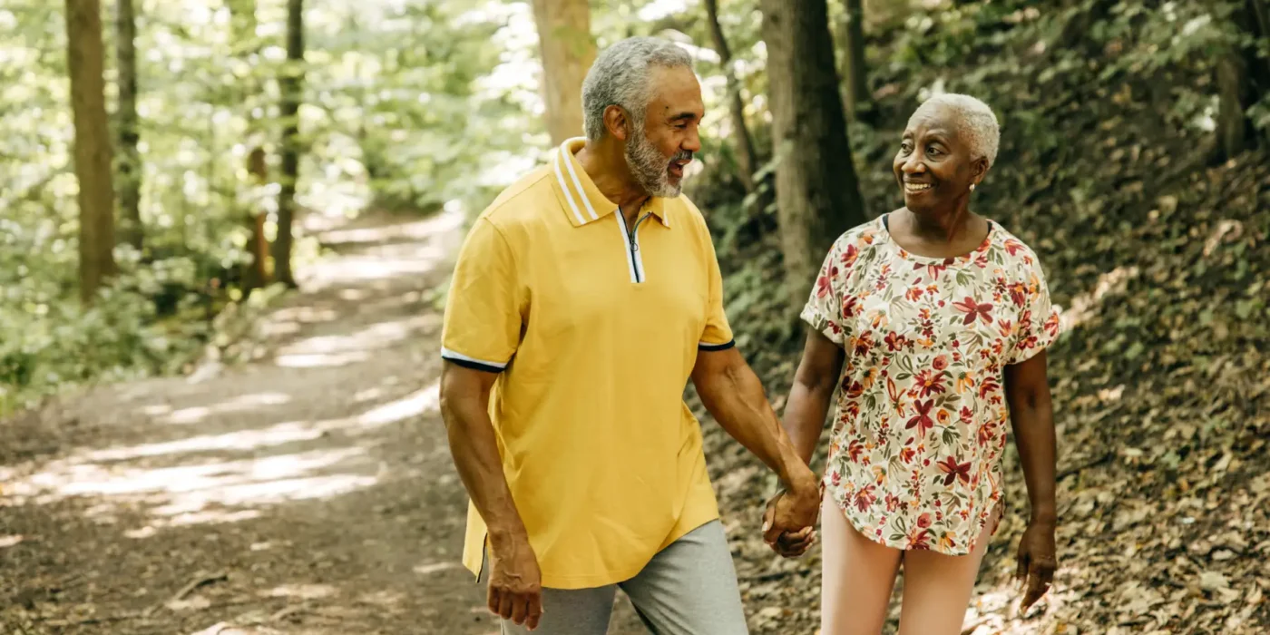 a senior couple taking an outdoor hike together