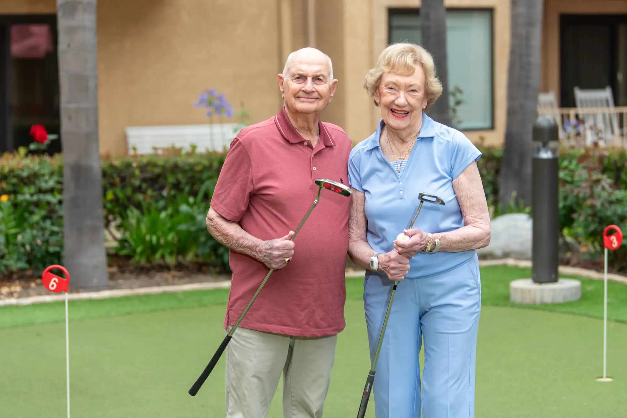 Couple at Freedom Village, a Life Plan Community, playing golf