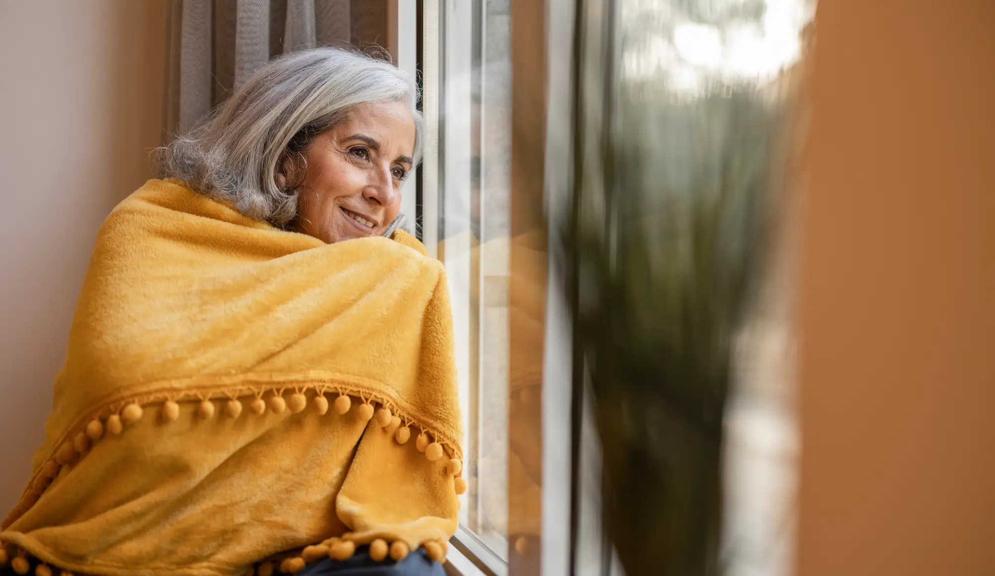 Senior woman wrapped in blanket