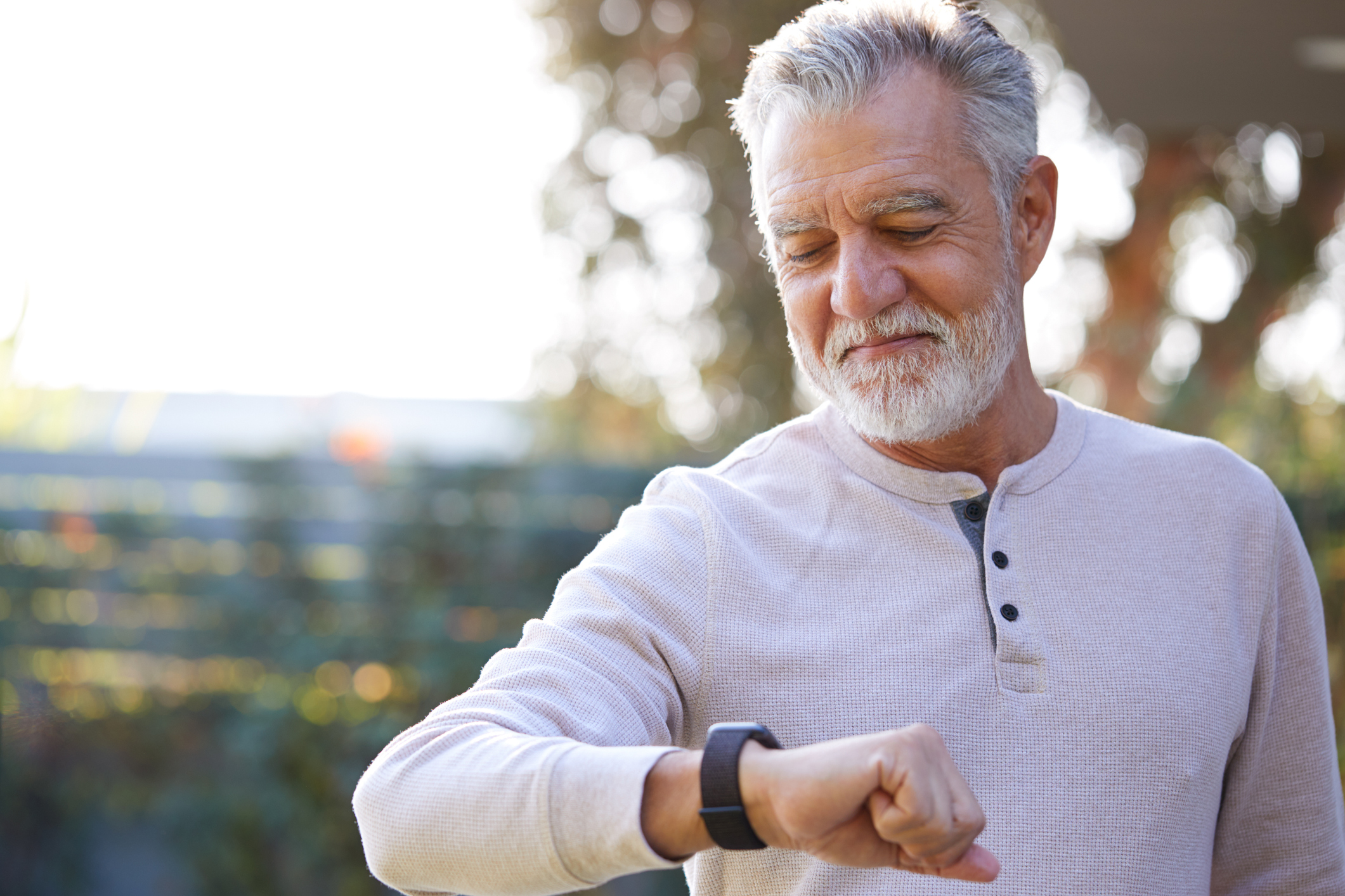 senior man looking at smart watch