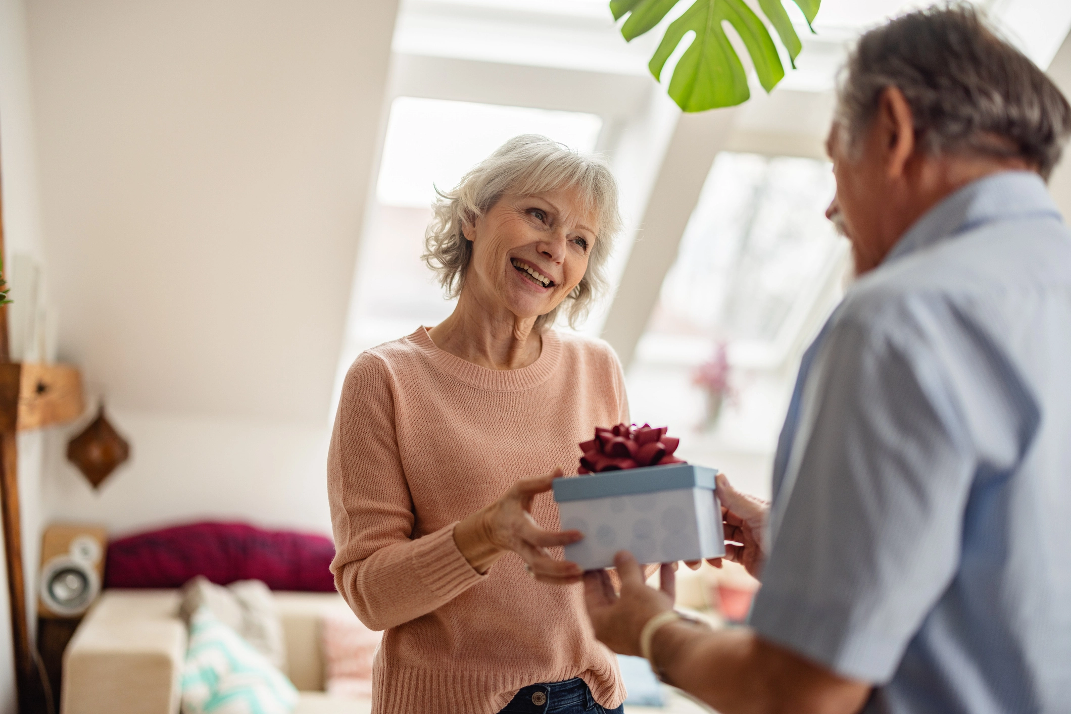 senior man giving senior woman flowers