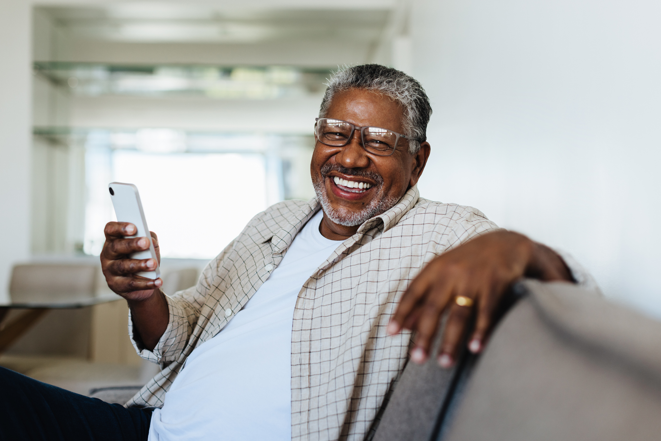 Senior man holding cell phone and smiling