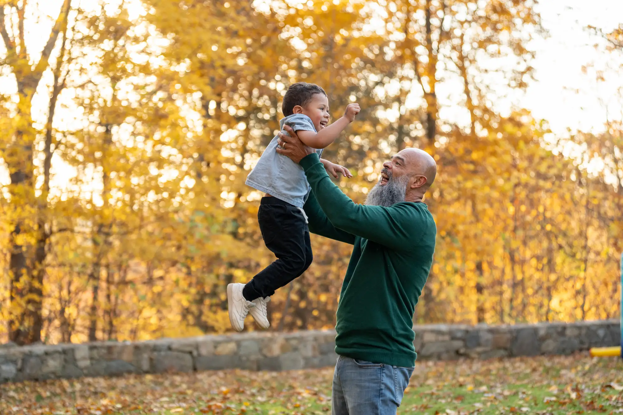 grandfather lifting grandson outside