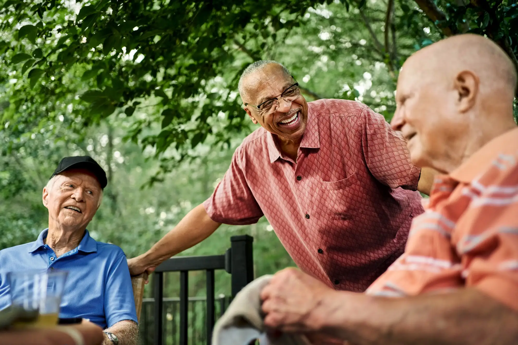 independent senior men laughing on a deck