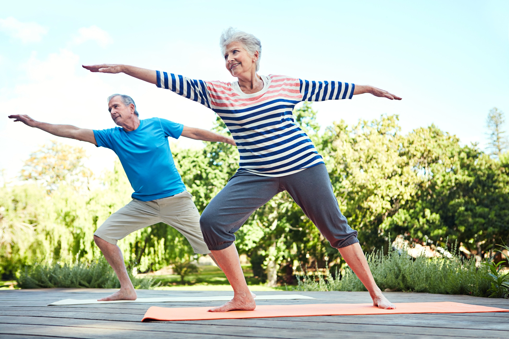 two seniors practicing yoga