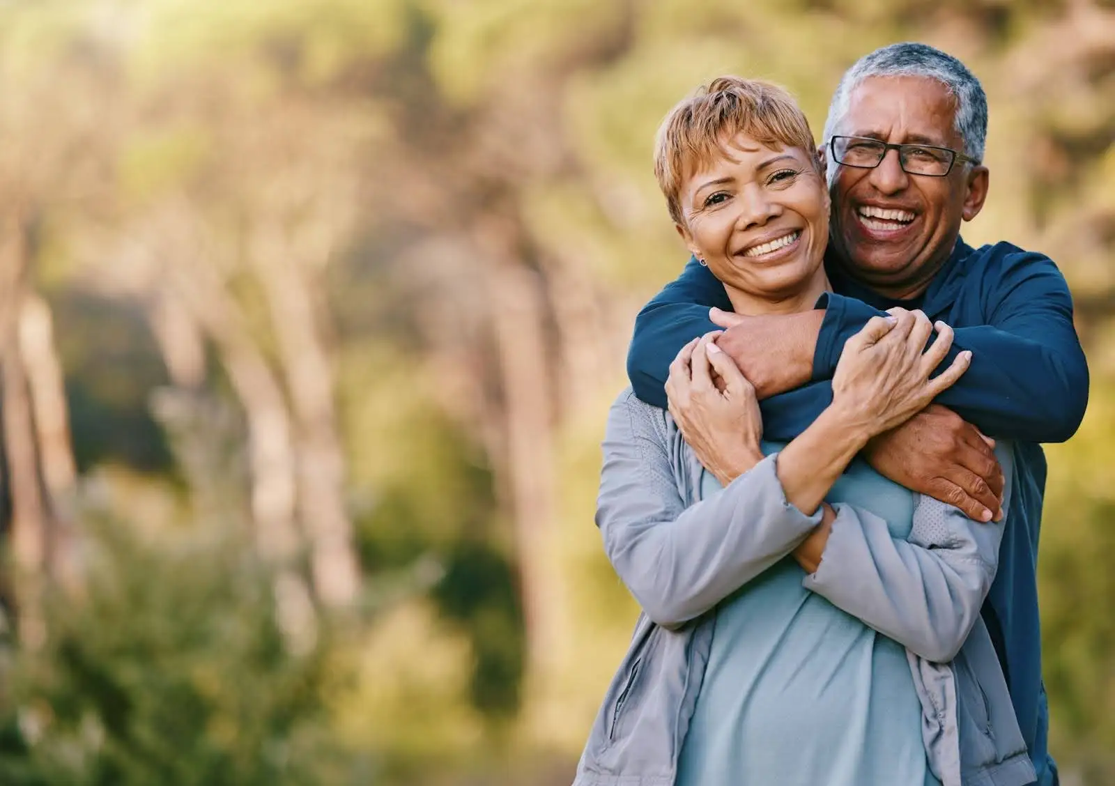 Senior couple hugging after discussing when to move to senior living.