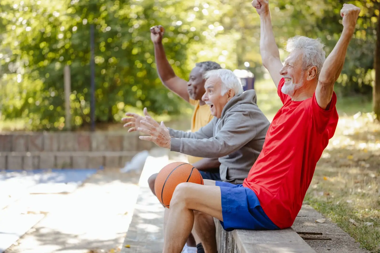 senior men playing basketball and considering when to move to senior living